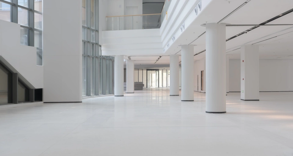 Modern white interior with large columns and windows