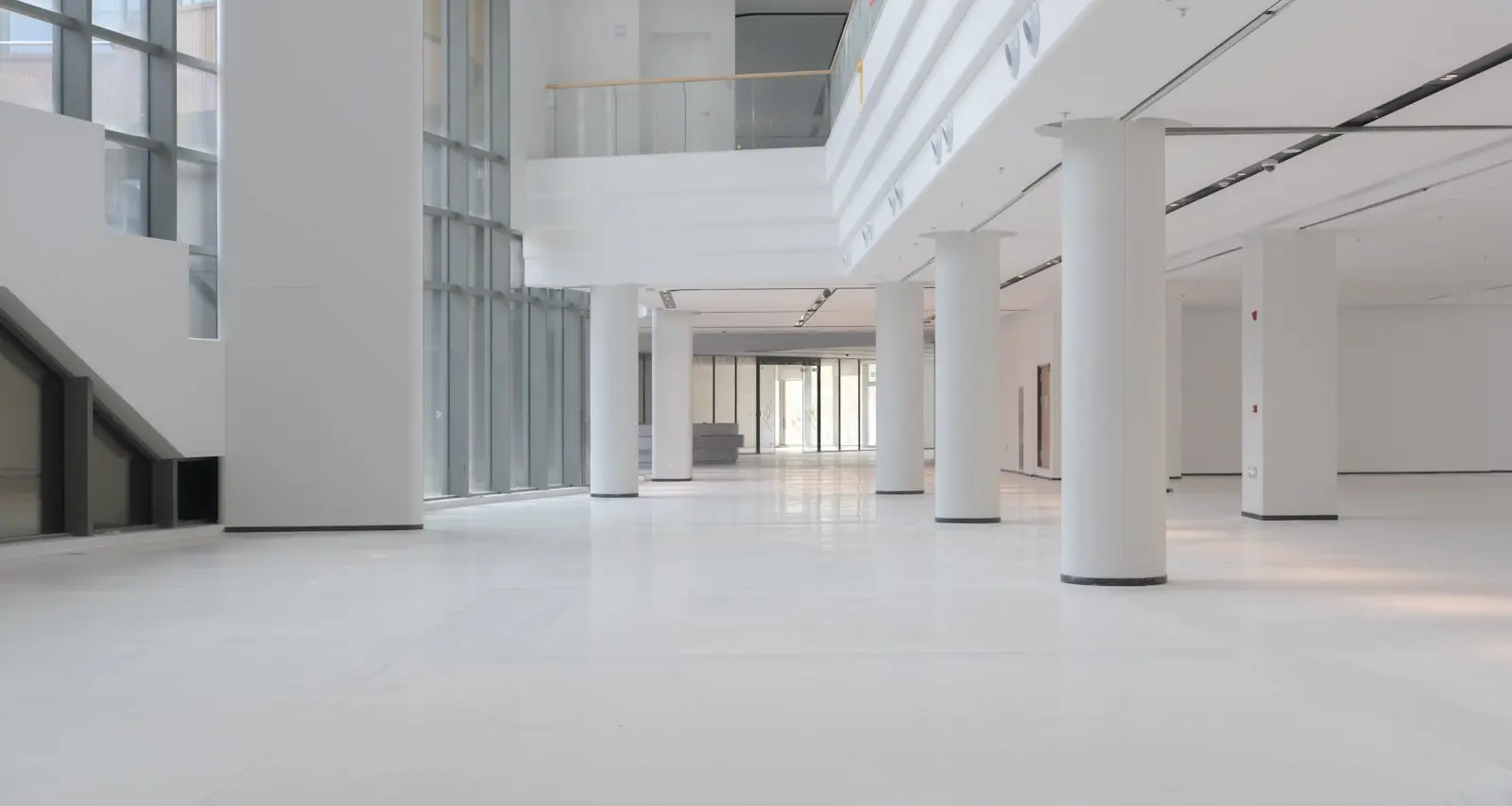 Modern white interior with large columns and windows