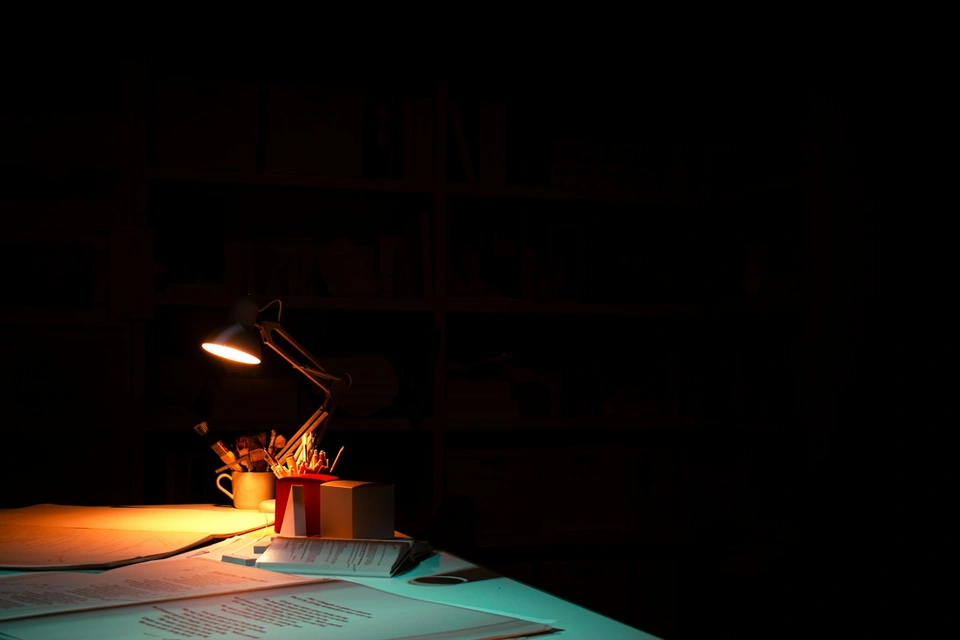 A table with a lit candle on top of it