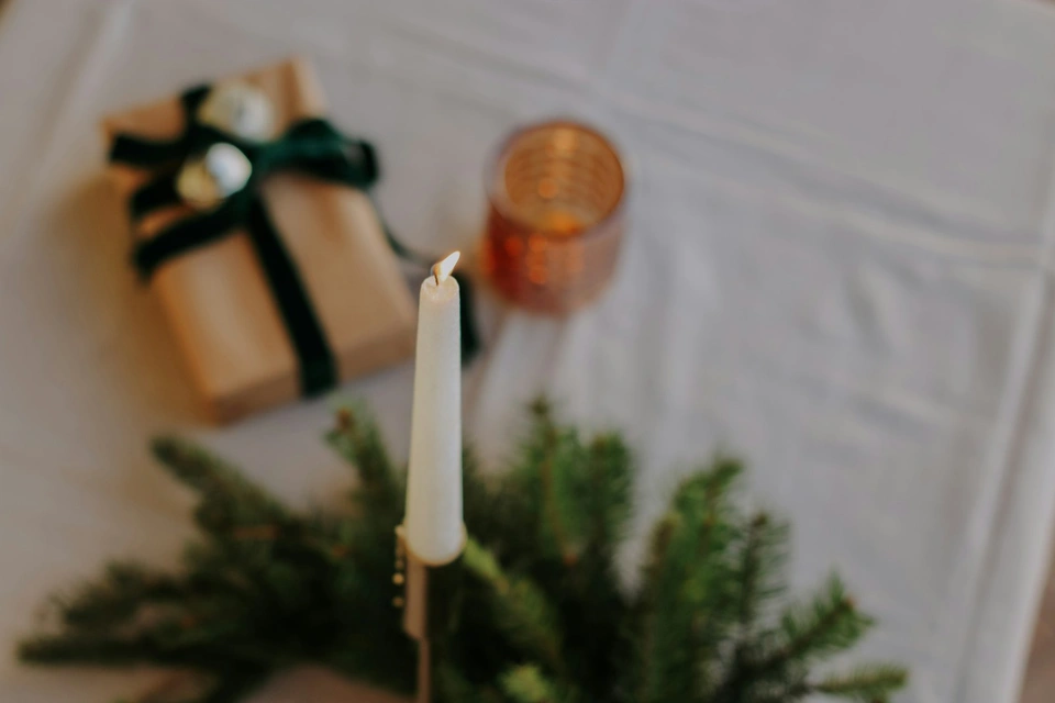 a lit candle sitting on top of a table